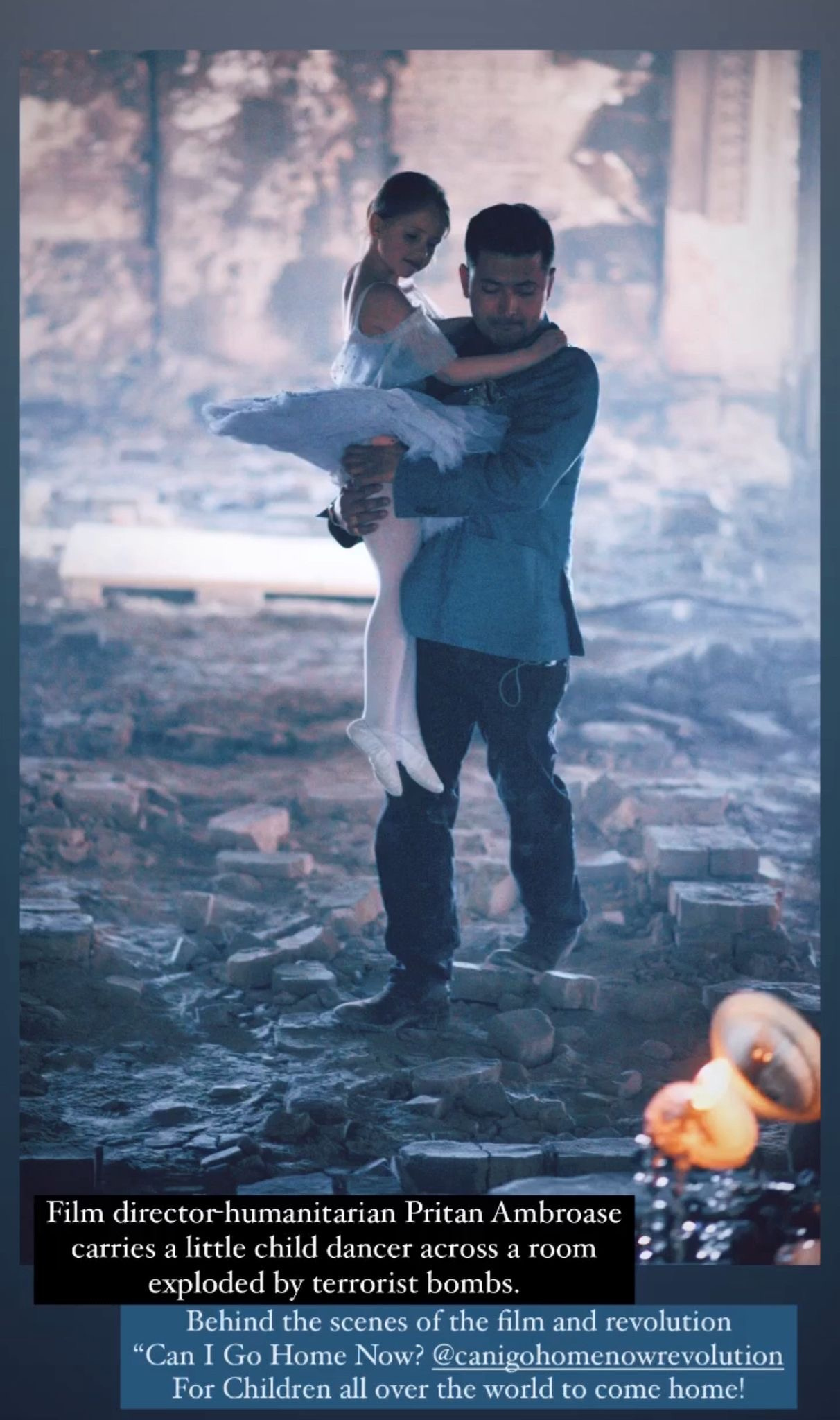 Film director-humanitarian Pritan Ambroase carries a little child dancer